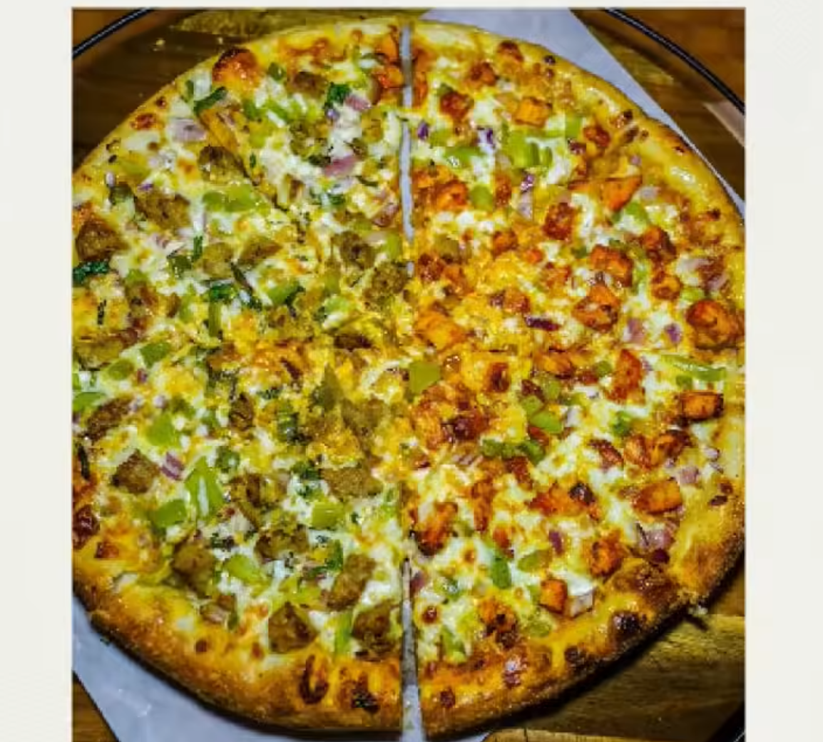 Pizza with various toppings on a wooden board